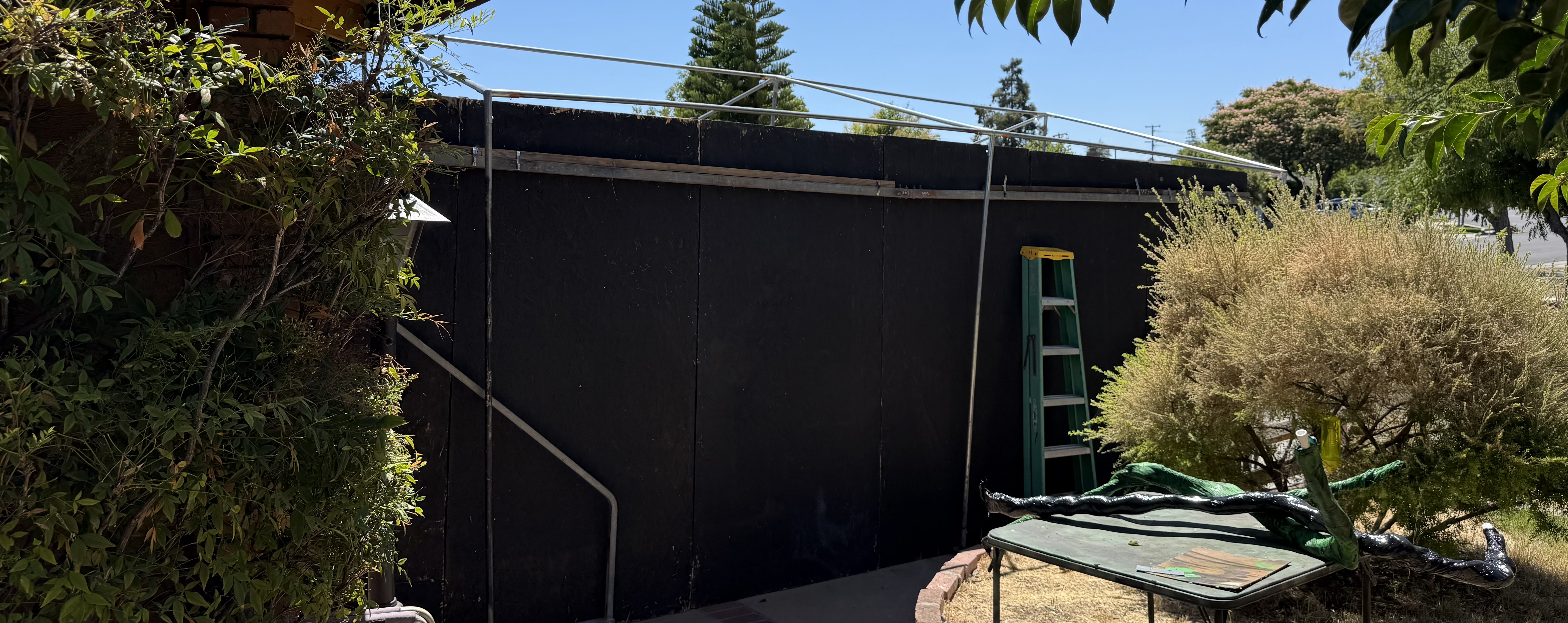 a temporary haunted house building under construction in a driveway